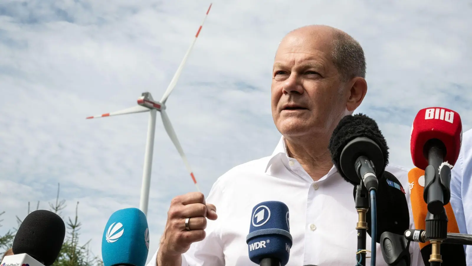 Bundeskanzler Olaf Scholz (SPD) spricht bei seinem Besuch eines Bürgerwindparks zu Journalisten. (Foto: Bernd Thissen/dpa)