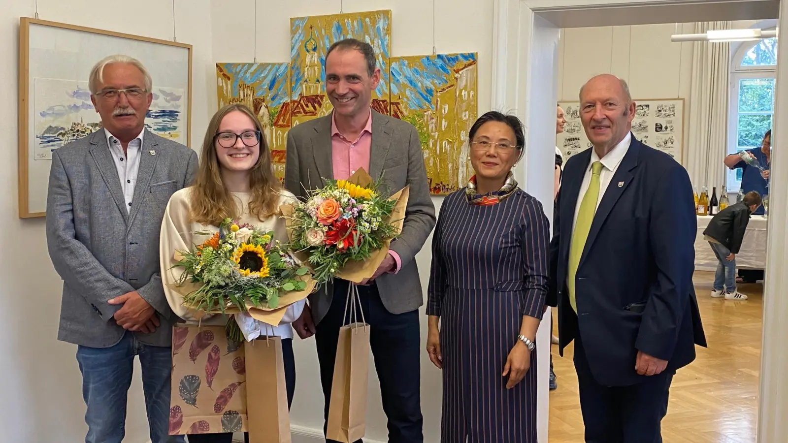 Dr. Andreas Hasenstab (Mitte) präsentiert im Doerfler-Museum gut 50 seiner Werke. Das Foto zeigt ihn bei der Vernissage mit (von links) zweitem Bürgermeister Herbert Seidel, Musikerin Klara Neidhardt, Museumsleiterin Hai Yan Waldmann-Wang und Rathauschef Michael Trzybinski. (Foto: Doerfler-Museum)