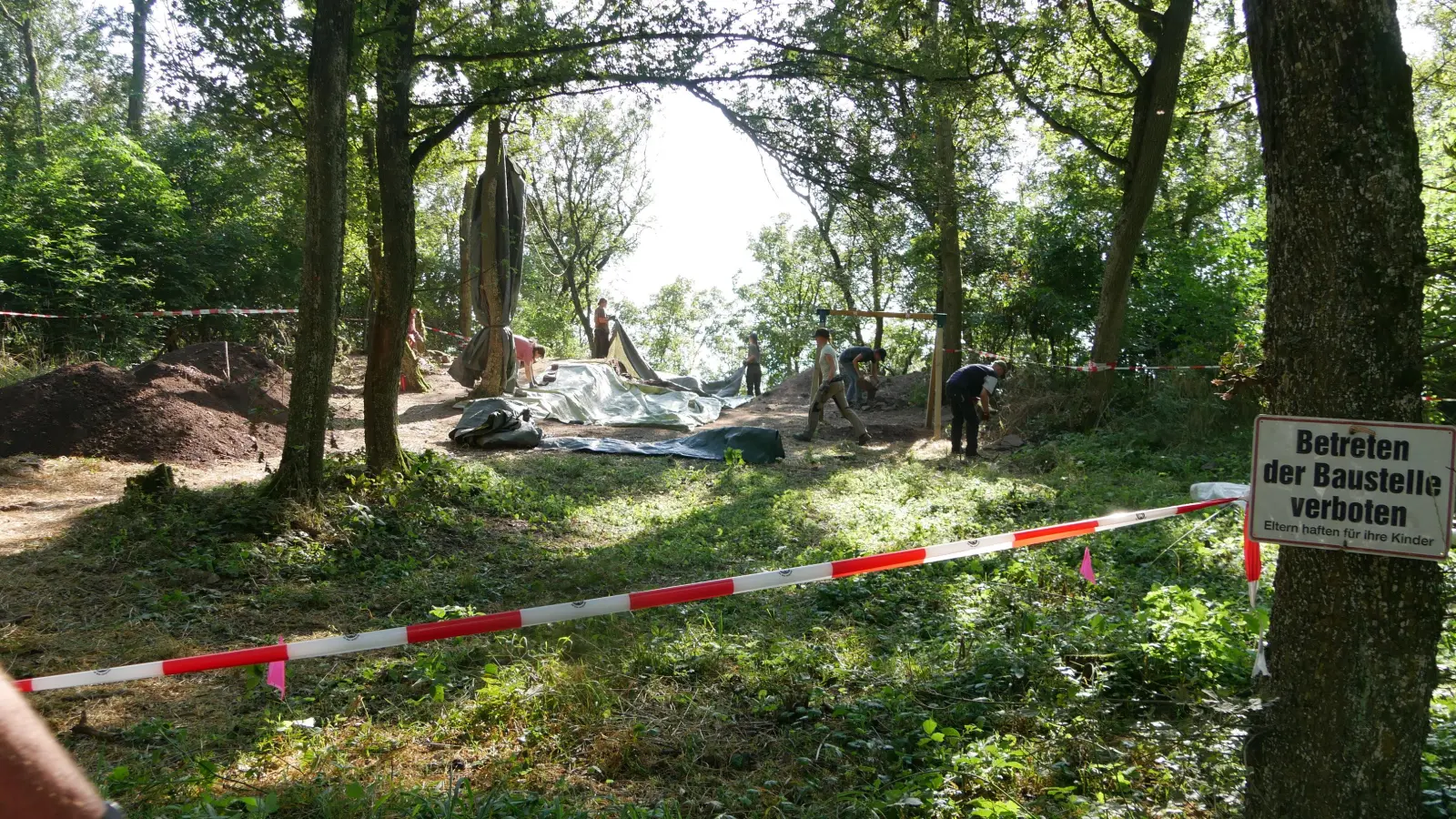 Nach der Führung legten die Studenten und Studentinnen eine Plane auf die Grabungsstelle. Inzwischen ist die Grabung beendet und das etwa 25 Meter lange und zwei Meter breite Bodenprofil wieder zugedeckt. (Foto: Ulli Ganter)