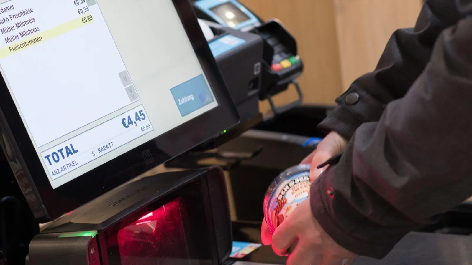 Ein Mann scannt im Edeka-Markt in Kassel Lebensmittel an einer SB-Kasse. (Foto: Swen Pförtner/dpa)