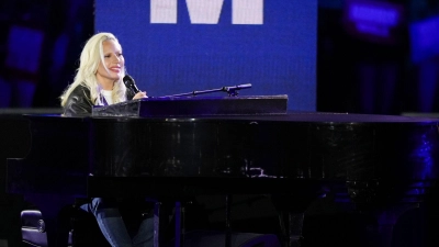 Lady Gaga performt vor ikonischer Kulisse „God bless America“ am Klavier.  (Foto: Matt Slocum/AP/dpa)