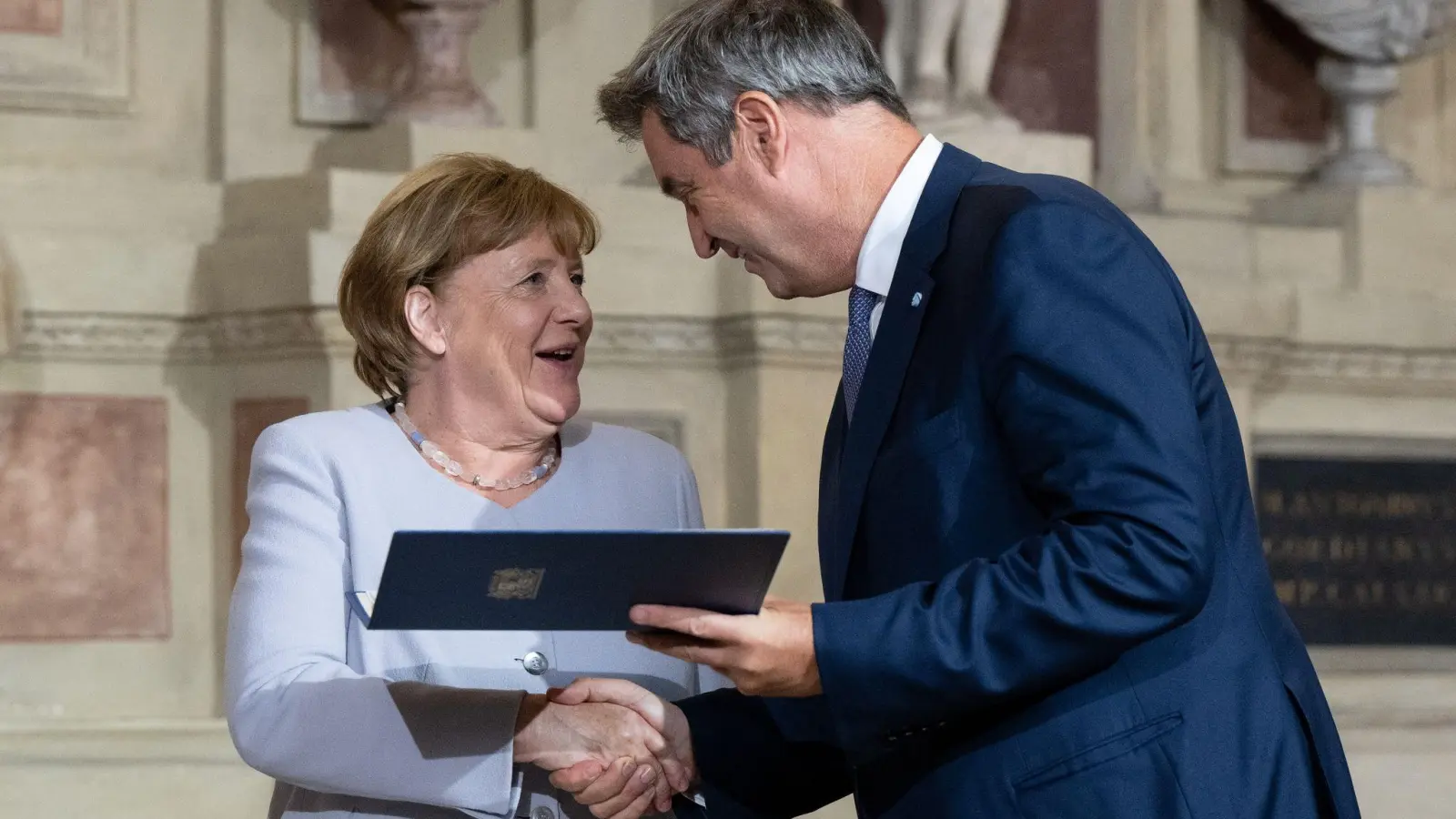 Markus Söder (CSU), Ministerpräsident von Bayern, verleiht Angela Merkel (CDU) den Bayerischen Verdienstorden. (Foto: Sven Hoppe/dpa)