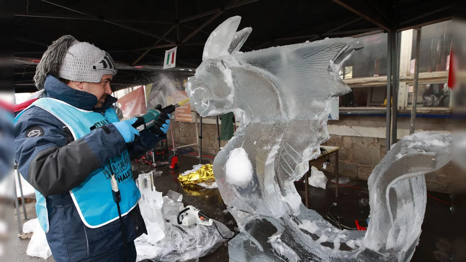 Weltcup im Eisskulpturenschnitzen: Ein Teilnehmer des Eisskulpturen Weltcup bearbeitet einen Eisblock mit einem Werkzeug. (Foto: Matthias Bein/dpa)