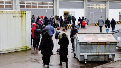 Menschen stehen Schlange bei der Essenausgabe in der Landesunterkunft der Gemeinde Seeth im Kreis Nordfriesland. (Foto: Frank Molter/dpa)