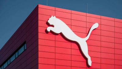 Ein Puma Logo ist an der Wand des Puma Outlets zu sehen. (Foto: Daniel Vogl/dpa/Archivbild)