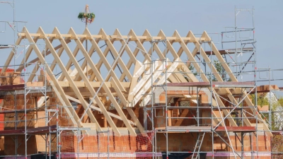 Mit einem Kranz wird beim Neubau eines Einfamilienhauses in der Region Hannover Richtfest gefeiert. (Foto: Mia Bucher/dpa)