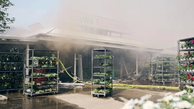 Feuerwehrleute löschen einen Brand in einem Baumarkt in Pocking. (Foto: Tobias C. Köhler/dpa)