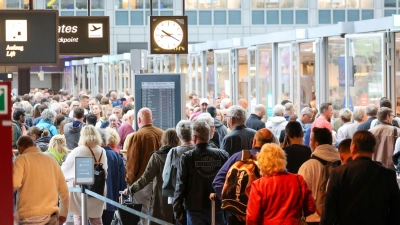 Reisende warten in langen Schlangen vor der Sicherheitskontrolle am Flughafen Hamburg auf die Abfertigung. (Foto: Bodo Marks/dpa)